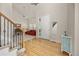 The light and airy foyer boasts hardwood floors, staircase, and a glimpse of the living room at 14246 Piney River Rd, Broomfield, CO 80023