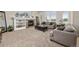 Living room offers a fireplace, mantel, large windows, and comfortable neutral furniture at 14246 Piney River Rd, Broomfield, CO 80023