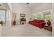 Bright living room with neutral walls, a high ceiling, and a comfortable red sofa at 14246 Piney River Rd, Broomfield, CO 80023