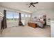 Spacious primary bedroom with vaulted ceiling, large windows and decorative stone fireplace at 14246 Piney River Rd, Broomfield, CO 80023