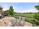 Stone patio with outdoor dining set and scenic views of community green spaces at 14246 Piney River Rd, Broomfield, CO 80023