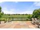 Stone patio with outdoor seating provides a scenic view of the community green space at 14246 Piney River Rd, Broomfield, CO 80023