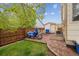 A backyard with green grass, a fence, a motorbike and a storage shed at 4759 Mt Princeton, Brighton, CO 80601