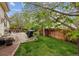 Backyard featuring green grass, a fence, a concrete patio, an outdoor grill and table set at 4759 Mt Princeton, Brighton, CO 80601