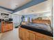 A bedroom that features a bed with a wooden frame, a TV, dresser, and a light blue wall at 4759 Mt Princeton, Brighton, CO 80601