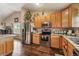 Clean kitchen features wood cabinets, stainless steel appliances, and wood flooring at 4759 Mt Princeton, Brighton, CO 80601