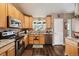 Well-lit kitchen featuring wood cabinets, granite countertops, and stainless steel appliances at 4759 Mt Princeton, Brighton, CO 80601
