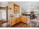 Open kitchen area with wood cabinets, granite countertops, and seamless flow to dining room at 4759 Mt Princeton, Brighton, CO 80601