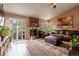 Comfortable living room with a fireplace, leather furniture, and sliding glass doors to the yard at 4759 Mt Princeton, Brighton, CO 80601