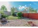 View of a backyard featuring grass, mulch, bushes, and wood fence at 4480 S Pennsylvania St, Englewood, CO 80113