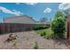 Fenced backyard with mature landscaping, wood chips, and potential for outdoor enjoyment at 4480 S Pennsylvania St, Englewood, CO 80113