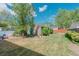 Spacious backyard with lush lawn, storage shed, and mature trees, creating a private outdoor retreat at 4480 S Pennsylvania St, Englewood, CO 80113