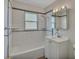 Brightly lit bathroom with white subway tile, modern fixtures, and a combination tub and shower, providing a clean design at 4480 S Pennsylvania St, Englewood, CO 80113