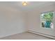 Bedroom with carpet, baseboard heating and a large window to the outside at 4480 S Pennsylvania St, Englewood, CO 80113