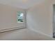 A bright bedroom featuring neutral-toned walls, carpet, and a large window for natural light at 4480 S Pennsylvania St, Englewood, CO 80113