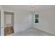 Bright bedroom with neutral tones, a window and closet, and a glimpse into an adjoining room at 4480 S Pennsylvania St, Englewood, CO 80113