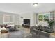 Bright living room features wood floors, stylish decor, and large windows offering plenty of natural light at 4480 S Pennsylvania St, Englewood, CO 80113