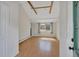 Open living area with light wood floors, large windows, and exposed ceiling beams at 4480 S Pennsylvania St, Englewood, CO 80113