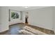 Bright, freshly painted living room with new flooring and a window view, leading seamlessly into the kitchen at 4480 S Pennsylvania St, Englewood, CO 80113