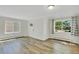 Spacious living room features new wood floors, fresh paint, and bright windows, offering a fresh living space at 4480 S Pennsylvania St, Englewood, CO 80113