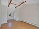 Spacious living room with light wood floors, beams and a large window at 4480 S Pennsylvania St, Englewood, CO 80113