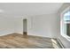 Bright living room with hardwood floors, white walls, and a large window for plenty of natural light at 4480 S Pennsylvania St, Englewood, CO 80113
