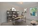 Well-lit office space with open shelving, a modern desk, and views of the outdoors, perfect for productivity at 4480 S Pennsylvania St, Englewood, CO 80113