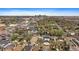 Scenic aerial view of a neighborhood, showcasing mature trees and the distant city skyline at 1423 Xavier St, Denver, CO 80204