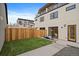Serene backyard oasis with lush grass, modern patio furniture, and privacy fence at 1423 Xavier St, Denver, CO 80204