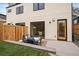 Serene backyard oasis with modern patio furniture, privacy fence, and ample space for outdoor enjoyment at 1423 Xavier St, Denver, CO 80204