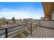 Modern balcony with sleek black railings and wood-look decking provides a view of the neighborhood at 1423 Xavier St, Denver, CO 80204