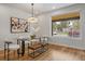 Elegant dining area with a large window, stylish lighting, and seating at 1423 Xavier St, Denver, CO 80204