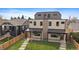 Contemporary two-story duplex with a manicured lawn and modern architectural details at 1423 Xavier St, Denver, CO 80204