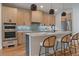 Bright kitchen boasts modern cabinets, stainless steel appliances, and a large island with seating at 1423 Xavier St, Denver, CO 80204