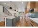 Modern kitchen boasts a central island, sleek appliances, and a view into the dining area at 1423 Xavier St, Denver, CO 80204