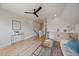 Bright living room featuring light wood floors, a stylish ceiling fan, and a wet bar with modern finishes at 1423 Xavier St, Denver, CO 80204