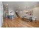 Open-concept living space with hardwood floors, modern lighting, and a staircase at 1423 Xavier St, Denver, CO 80204