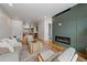 Inviting living room featuring a modern fireplace, hardwood floors, and comfortable seating arrangement at 1423 Xavier St, Denver, CO 80204