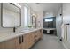 Luxurious main bathroom featuring dual vanities, sleek mirrors, and a freestanding tub at 1423 Xavier St, Denver, CO 80204