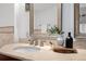 Elegant bathroom with a vessel sink, stone countertop, modern fixtures, and a decorative mirror at 1891 Curtis St # 1820, Denver, CO 80202