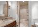 Modern bathroom with a glass-enclosed shower featuring tile, built-in bench, and updated fixtures at 1891 Curtis St # 1820, Denver, CO 80202