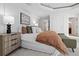 This bedroom features a plush bed with a brown cover, complemented by a side table and elegant decor at 1891 Curtis St # 1820, Denver, CO 80202