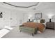 Bright bedroom features a bed with a brown cover, a green bench, and white doors and trim at 1891 Curtis St # 1820, Denver, CO 80202
