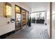 Grand building entrance with tiled walkway, decorative lighting, and manicured greenery at 1891 Curtis St # 1820, Denver, CO 80202