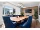 Bright conference room with large table, blue upholstered chairs, and city views at 1891 Curtis St # 1820, Denver, CO 80202