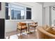 Bright dining area featuring a marble table with orange chairs, and a view of the downtown skyline at 1891 Curtis St # 1820, Denver, CO 80202