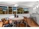 Bright dining area features hardwood floors, a stylish rug, and large windows with beautiful city views at 1891 Curtis St # 1820, Denver, CO 80202
