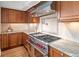 Gourmet kitchen with a stainless steel stovetop, granite countertops and hardwood flooring at 1891 Curtis St # 1820, Denver, CO 80202