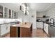 Modern kitchen features custom island, stainless appliances, black countertops, and decorative tile backsplash at 1891 Curtis St # 1820, Denver, CO 80202