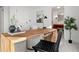 Bright office space with a large wooden desk, a modern lamp, a leather woven chair, and a relaxing area at 1891 Curtis St # 1820, Denver, CO 80202